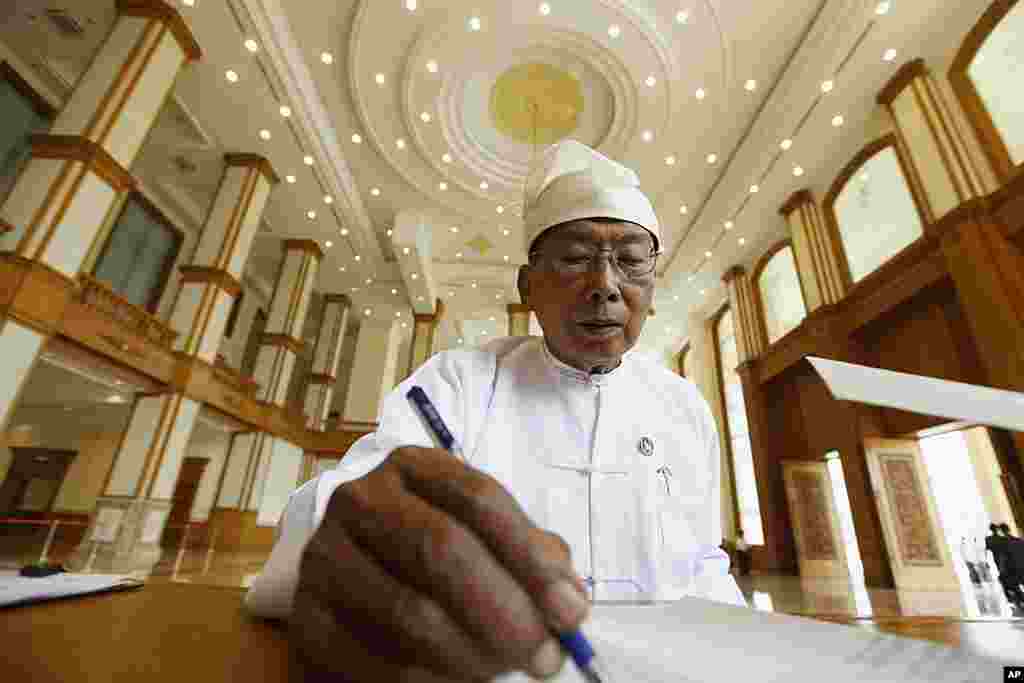 A member of the Upper House registers to attend the third session of the Upper House meeting. (Reuters)