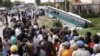 FILE - In this 2009 photo, crowds of people watch after a bus collided with a motorcycle on the outskirts of Phnom Penh, Cambodia. Traffic accidents are the leading cause of death in Cambodia, a road safety expert told the Hello VOA call-in program on June 29, 2016.