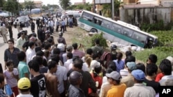 FILE - In this 2009 photo, crowds of people watch after a bus collided with a motorcycle on the outskirts of Phnom Penh, Cambodia. Traffic accidents are the leading cause of death in Cambodia, a road safety expert told the Hello VOA call-in program on June 29, 2016.