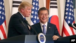 President Donald Trump, left, speaks as South Korean President Moon Jae-in looks on during a joint news conference at the Blue House in Seoul, South Korea, Tuesday, Nov. 7, 2017.