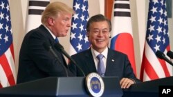 FILE - President Donald Trump, left, speaks as South Korean President Moon Jae-in looks on during a joint news conference at the Blue House in Seoul, South Korea, Nov. 7, 2017.