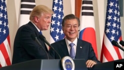 FILE - President Donald Trump, left, speaks as South Korean President Moon Jae-in looks on during a joint news conference at the Blue House in Seoul, South Korea, Nov. 7, 2017.