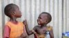FILE - Children play outside a community center at an internally displaced person's camp, in the capital Juba, South Sudan, April 2, 2019.