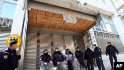 Riot police secure the entrance to the German Embassy during an anti-austerity protest in Athens, February 17, 2012.