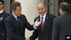 France's President Nicolas Sarkozy (L) welcomes Mustafa Abdel Jalil (C), chairman of the Libyan National Transitional Council (NTC), and Mahmoud Jibril (R), the head of Libya's rebel National Transitional Council, prior to the opening of the "Friends of L