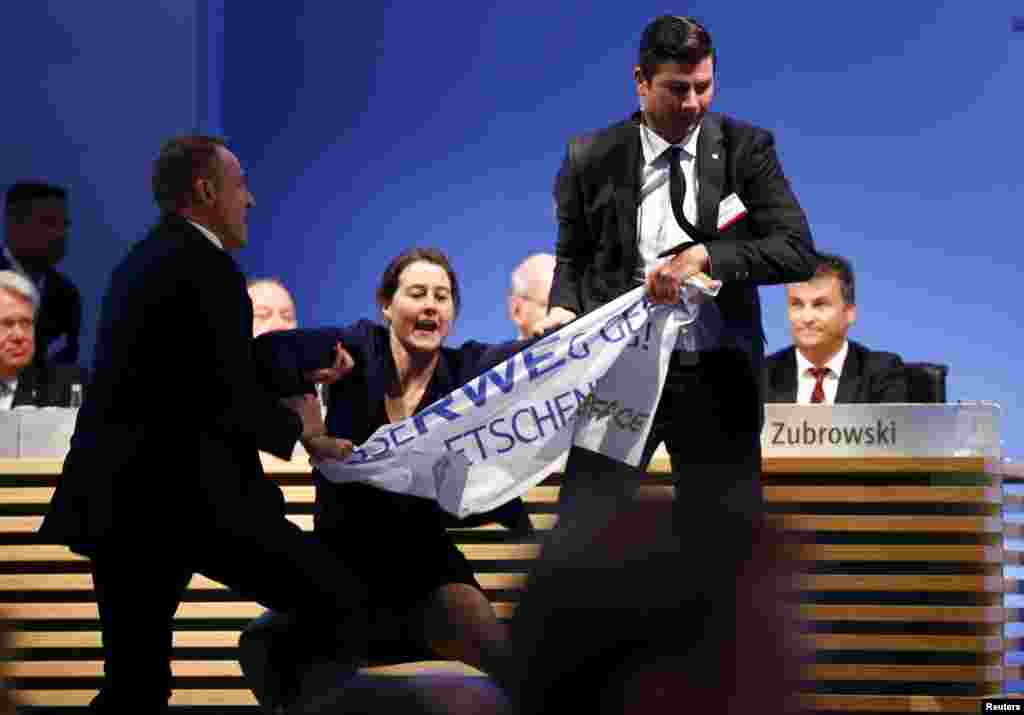 An environmental activist is pulled from the stage during the annual shareholders meeting of German power supplier RWE in Essen.