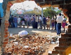 FILE - Survivors line up for relief in quake devastated Armenia, El Salvador, 39 kms (27 miles) from the El Savadoran capital, January 23, 2001.