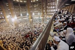 Muslim men attend a prayer at Istiqlal Mosque in Jakarta, Indonesia, Feb. 11, 2017. Tens of thousands gathered at the national mosque for the mass prayers urging Indonesians to vote for Muslims in city and district elections being held across the country