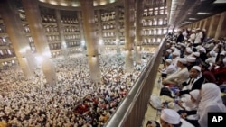 FILE - Muslim men attend a prayer at Istiqlal Mosque in Jakarta, Indonesia, Feb. 11, 2017. 