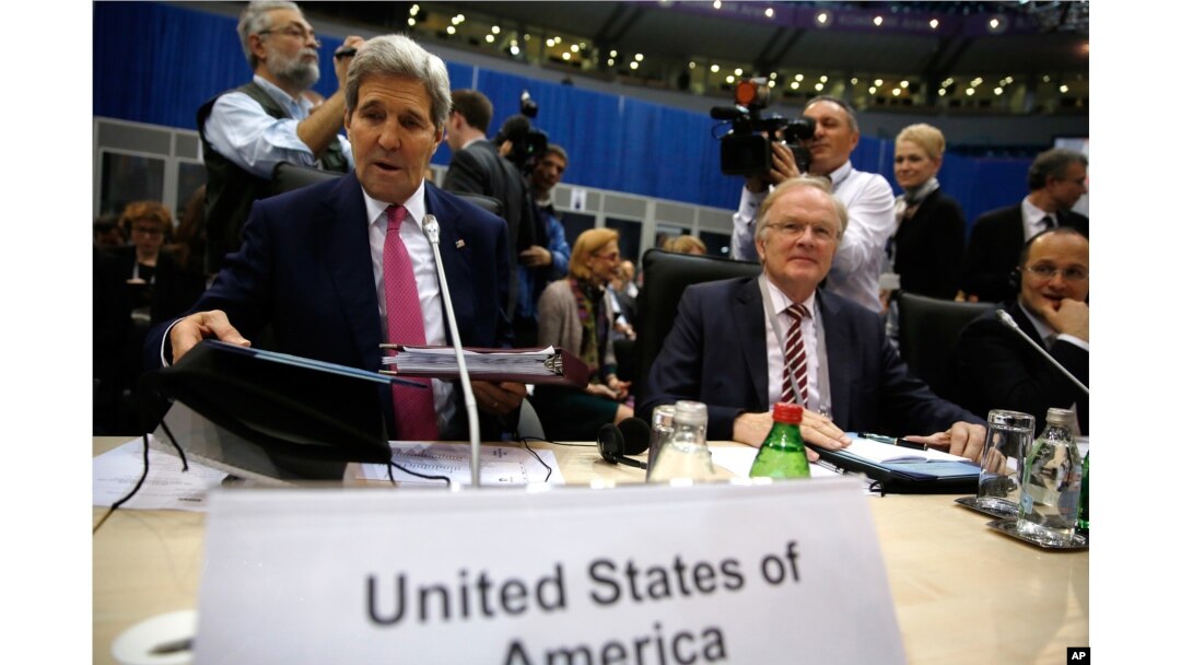 U.S. Secretary of State John Kerry, left, takes his seat to participate in the Organization for Security and Cooperation in Europe (OSCE) ministerial council meeting in Belgrade, Serbia Thursday, Dec. 3, 2015.