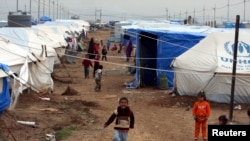 Displaced Iraqi children, who fled from Islamic State violence in Mosul, play in a refugee camp on the outskirts of the Kurdish city of Erbil, Dec. 1, 2014.