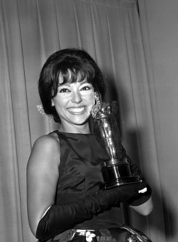 FILE - Actress Rita Moreno poses with her Oscar after she was named best supporting actress at the Academy Awards in Los Angeles on April 9, 1962. She won for her role in "West Side Story."