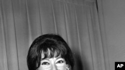 FILE - Actress Rita Moreno poses with her Oscar after she was named best supporting actress at the Academy Awards in Los Angeles on April 9, 1962. She won for her role in "West Side Story."
