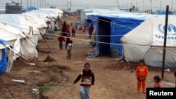 Displaced Iraqi children, who fled from Islamic State violence in Mosul, play in a refugee camp on the outskirts of the Kurdish city of Erbil, Dec. 1, 2014.