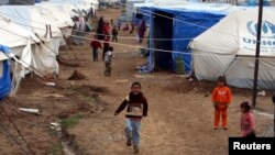 Displaced Iraqi children, who fled from Islamic State violence in Mosul, play in a refugee camp on the outskirts of the Kurdish city of Erbil, Dec. 1, 2014.