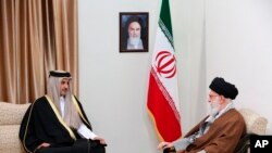 FILE - Supreme Leader Ayatollah Ali Khamenei, right, meets Emir of Qatar Sheikh Tamim bin Hamad al-Thani at his office in Tehran, Jan. 12, 2020. (Office of the Iranian Supreme Leader via AP)