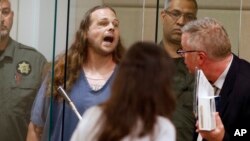 Jeremy Joseph Christian shouts as he is arraigned in Multnomah County Circuit Court in Portland, Oregon, May 30, 2017. 