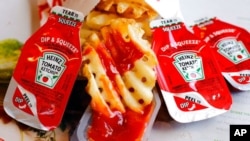 FILE - Ketchup packets are seen at a fast food restaurant in Robinson Township, Pa., March 30, 2015. 