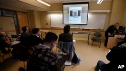 Students in a journalism course at Kean University in Union, N.J., watch a presentation on fake news, Jan. 20, 2017.