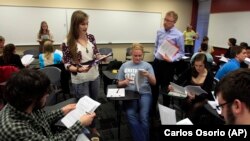 An academic advisor for the Alma College Model U.N. program listens to a student's presentation during class at Alma College, a tiny, north-central Michigan liberal arts school in Michigan.