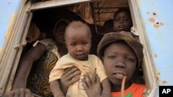 A South Sudanese family waits inside a train in Khartoum to be transported to Wau in South Sudan, March 1, 2012. 