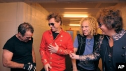 From left Tico Torres, Jon Bon Jovi, David Bryan, and Richie Sambora from US rock band Bon Jovi share a laugh backstage in Munich, June 12, 2011
