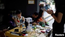 Protesters charge their mobile phones outside of an art centre near the government headquarters building in Hong Kong, Oct. 1, 2014. 