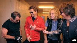 From left Tico Torres, Jon Bon Jovi, David Bryan, and Richie Sambora from US rock band Bon Jovi share a laugh backstage in Munich, June 12, 2011