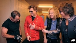 From left Tico Torres, Jon Bon Jovi, David Bryan, and Richie Sambora from US rock band Bon Jovi share a laugh backstage in Munich, June 12, 2011