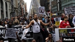 Demonstrators protest against police brutality against minorities during a protest in New York, April 14, 2015. 