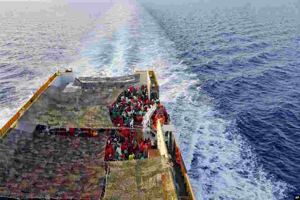 Migrants crowd the deck of the Norwegian Siem Pilot ship sailing along the Mediterranean sea. The Siem Pilot is carrying hundreds of migrants rescued in several operations in the Mediterranean sea, to the Italian Port of Cagliari. 