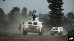 FILE - United Nations armored personnel carriers are seen north of the provincial capital of Goma, eastern Democratic Republic of Congo, Aug. 30, 2013. The U.N. appears to have lost two of its investigators who went missing in central Congo March 12, 2017. Bodies likely belonging to the two were found in Kasai province Tuesday, according to a government spokesman.