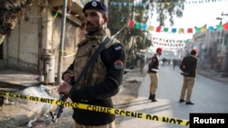 A policemen cordons off the site of a suicide blast in Rawalpini, Pakistan, Jan. 20, 2014.