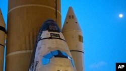 This image of space shuttle Discovery was taken as the craft began its nighttime trek, known as "rollout," from the Vehicle Assembly Building to Launch Pad 39A.