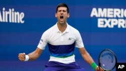 Novak Djokovic, of Serbia, reacts after scoring a point against Kei Nishikori, of Japan, during the third round of the US Open tennis championships, Sept. 4, 2021, in New York.