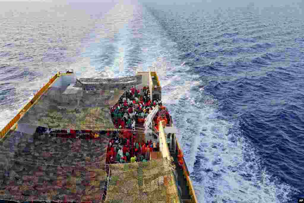 Migrants crowd the deck of the Norwegian Siem Pilot ship sailing along the Mediterranean sea. The Siem Pilot is carrying hundreds of migrants rescued in several operations in the Mediterranean sea, to the Italian Port of Cagliari. &nbsp;