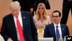 FILE - Ivanka Trump, daughter of U.S. President Donald Trump, left, attends a working session at the G-20 summit in Hamburg, northern Germany, July 8, 2017. Earlier this month, President Donald Trump left his chair at the G20 summit while Africa was discussed, having his daughter Ivanka sit in for him instead. Critics blasted the move as a breach of diplomatic protocol, but it also drew attention to the growing concern that when it comes to Africa, Trump has been notably absent.