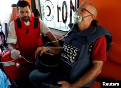 A journalist receives medical attention during an Israeli raid in Tulkarm, in the Israeli-occupied West Bank, on Aug. 3, 2024.