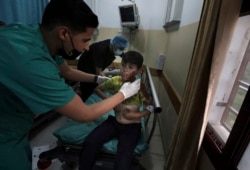 A medic treats a wounded boy following an explosion in the town of Beit Lahiya, northern Gaza Strip, on Monday, May 10, 2021, during a conflict between Hamas and Israel. (AP Photo/Mohammed Ali)