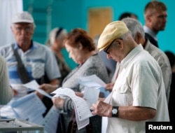 People visit a polling station during a parliamentary election in Stavropol, Russia, Sept. 18, 2016.