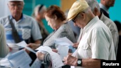 People visit a polling station during a parliamentary election in Stavropol, Russia, Sept. 18, 2016. 