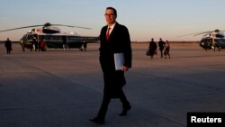 U.S. Treasury Secretary Steven Mnuchin walks to his car while returning to Washington with U.S. President Donald Trump aboard Air Force One, at Joint Base Andrews, Maryland, Feb. 5, 2018. 