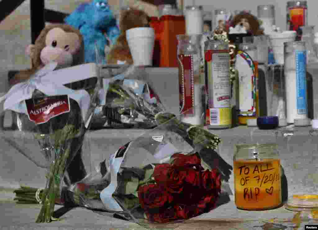 A view of the memorial site for the victims is seen behind the theater where a gunman opened fire on moviegoers in Aurora, Colorado July 21, 2012. 