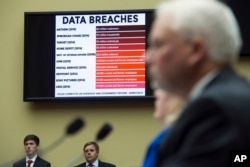 FILE - A chart of data breaches is shown on Capitol Hill in Washington, June 16, 2015.