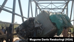 The mangled body of the truck that crashed into a passenger bus on Thursday, Dec. 11, 2014 on the Juba to Nimule highway in South Sudan. Three people were killed in the crash.
