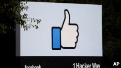 FILE - The entrance sign to Facebook headquarters is seen in Menlo Park, California.