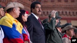 Venezuela's interim President Nicolas Maduro attends a ceremony marking the Day of the National Revolutionary Militia, also called Bolivarian militias, in Caracas, Venezuela, Saturday, Apr. 13, 2013. 