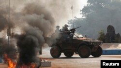 FILE - French troops secure an area along a street in Bangui, Central African Republic, Jan. 19, 2014.