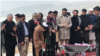 Afghan President Ashraf Ghani is seen laying the foundation stone for the future CASA-1000 transmission line at the groundbreaking site, east of the capital, Kabul, in a photo published Feb. 6, 2020, on his Twitter feed.