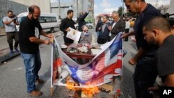 Palestinians stand around an effigy of Arthur Balfour during a protest on the anniversary of the Balfour Declaration in Bethlehem, West Bank, Nov. 1, 2017. The Balfour Declaration, Britain's promise to Zionists to create a Jewish home in what is now Israel, turns 100 this week.